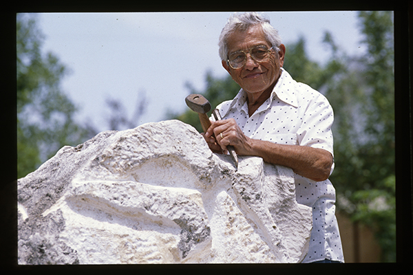 [Octavio Medellin with the Direct Carving Sculpture in Utah Honey Onyx, Mother and Child. Medellin Studio, Bandera, Texas]