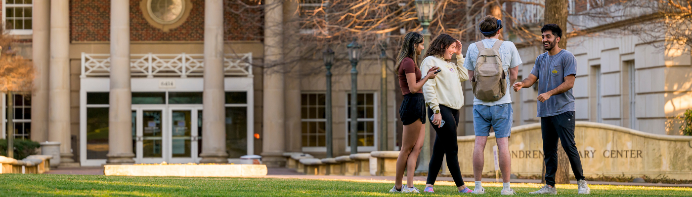 The front of Fondren Library with students in the distance