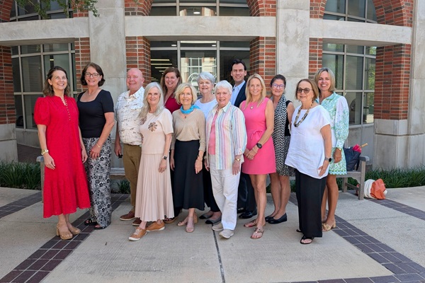 Friends of SMU Libraries Board Members for 2026-2027 standing in front on the bay window at Hamon Arts Library