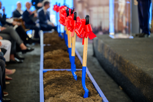 A row of blue shovels with bright red ribbons in a line, taken during the Rees-Jones groundbreaking