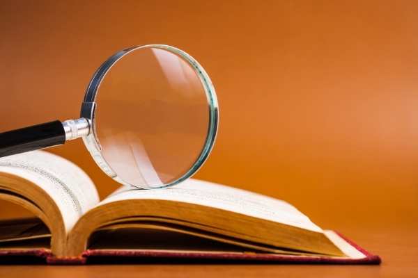 magnifying glass on book