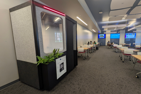 A small, one-person study space with a window and door 