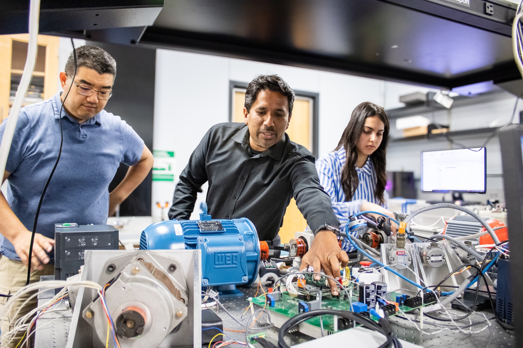 Expert faculty at SMU guide computer engineering graduate students in the laboratory.