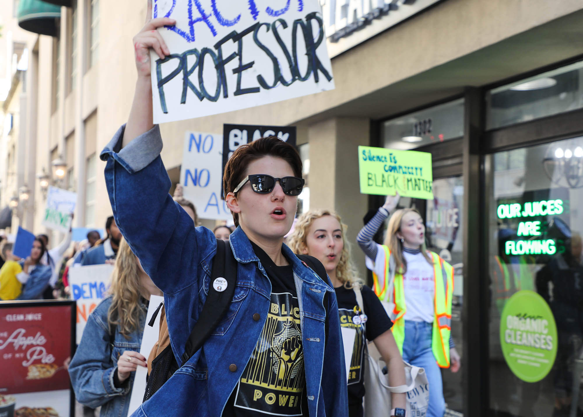 White man holding protest sign