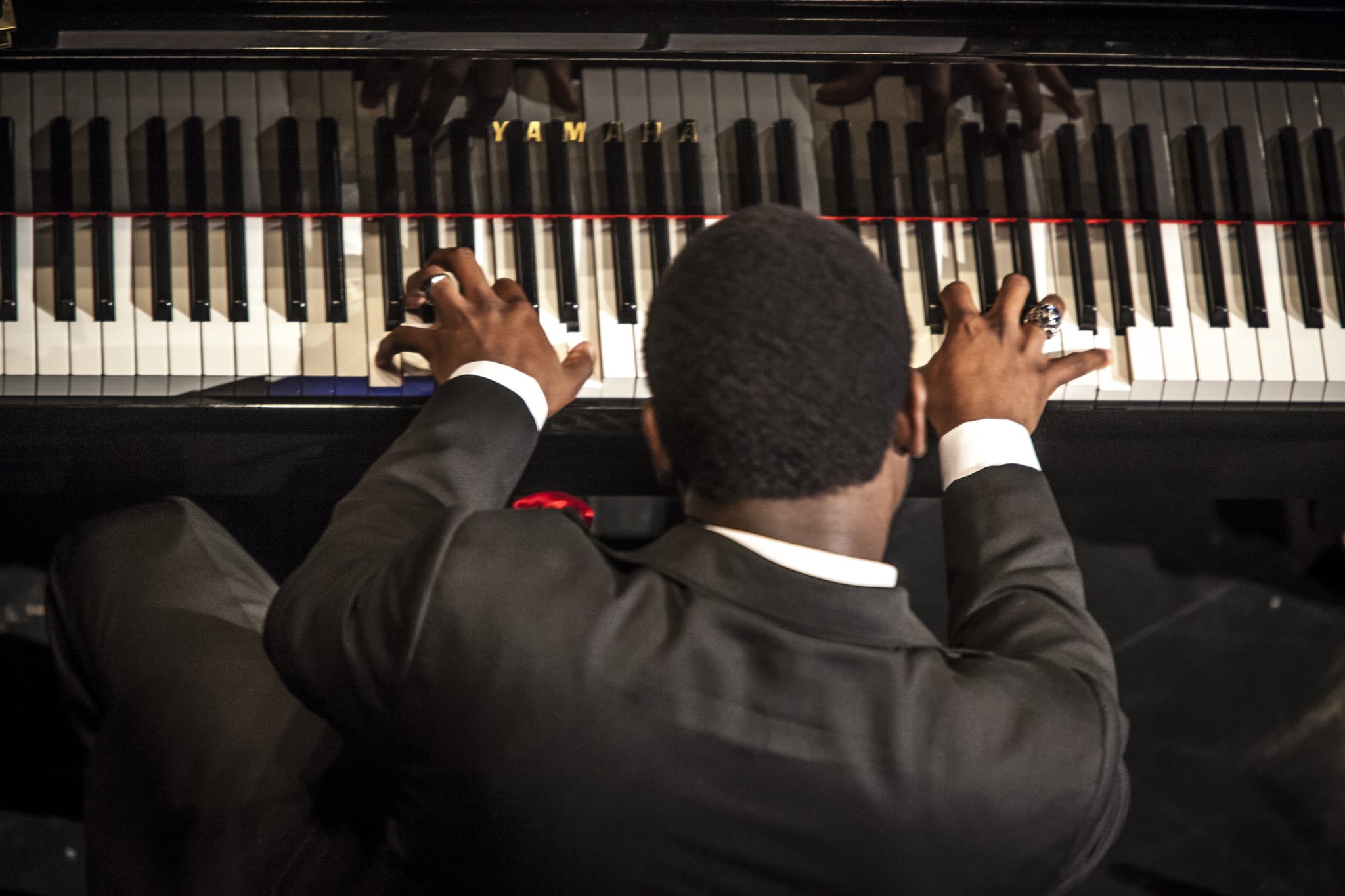 student playing piano shot from behind