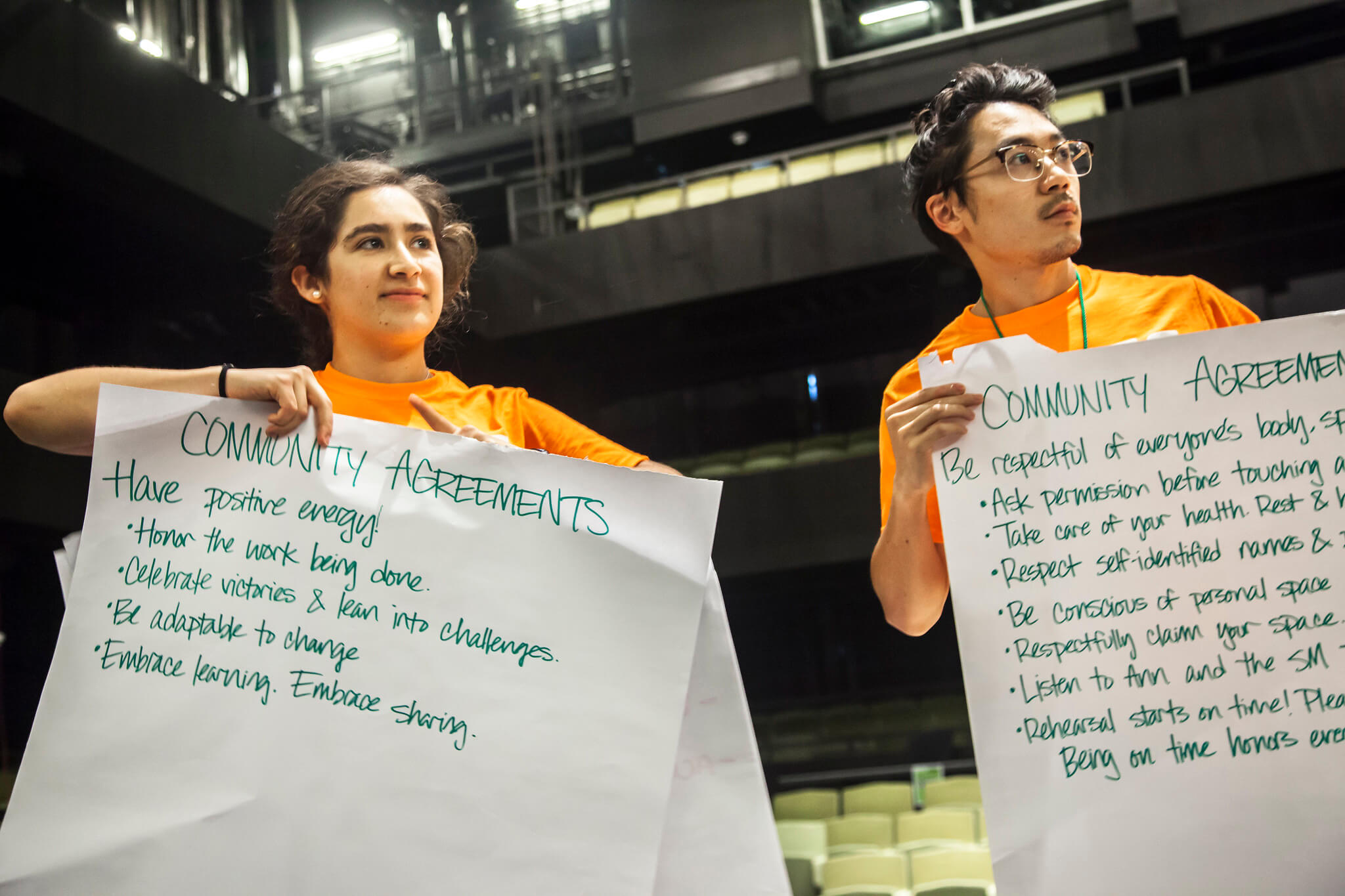 Two students holding large butcher paper with work