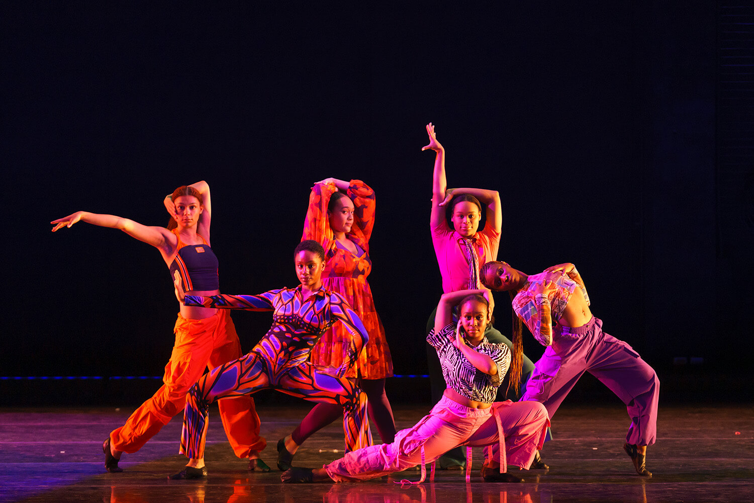 dancers on stage in red light