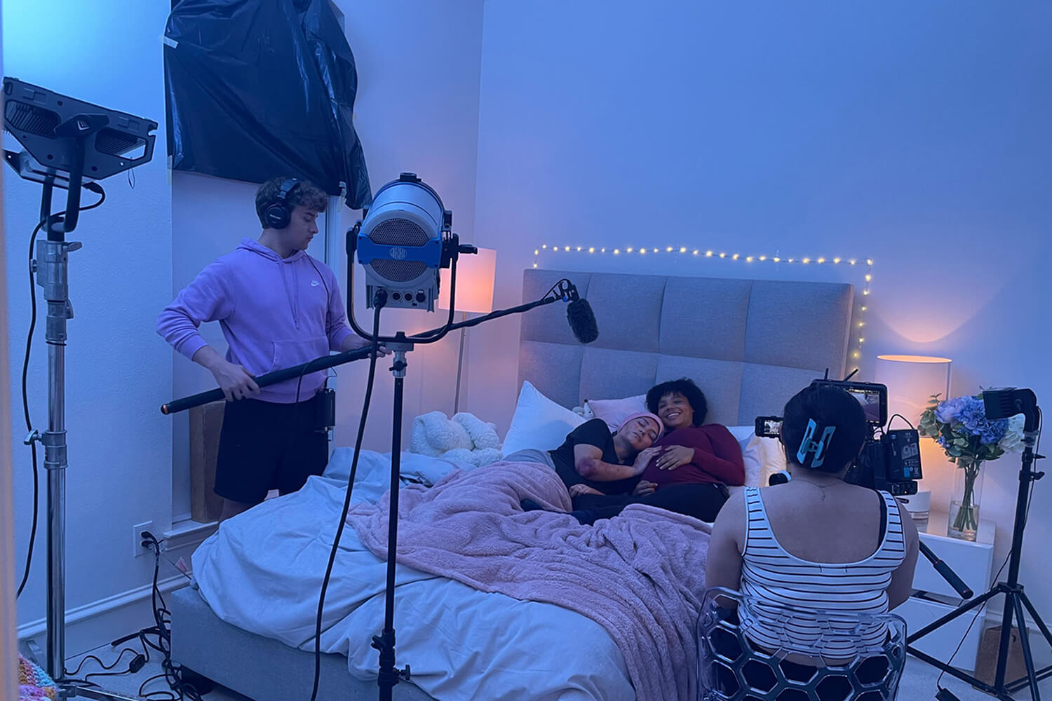 crew and actors on filmset in bed