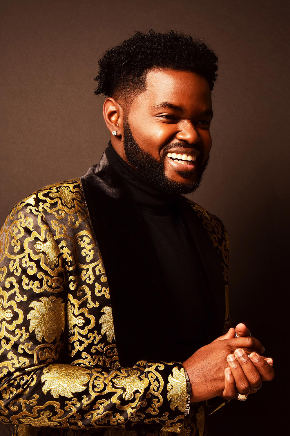 John Holiday wearing gold coat