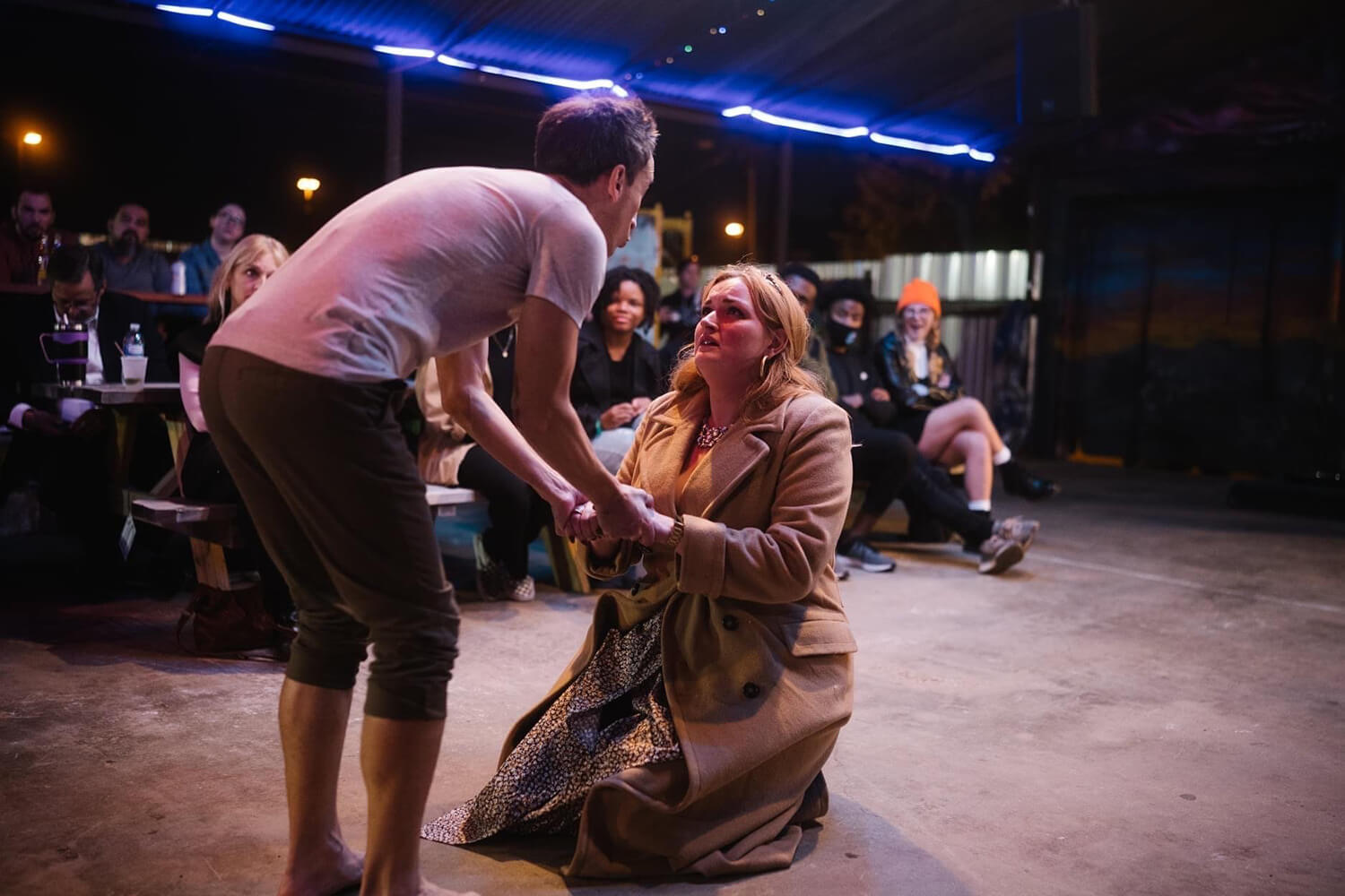 man and woman acting on stage