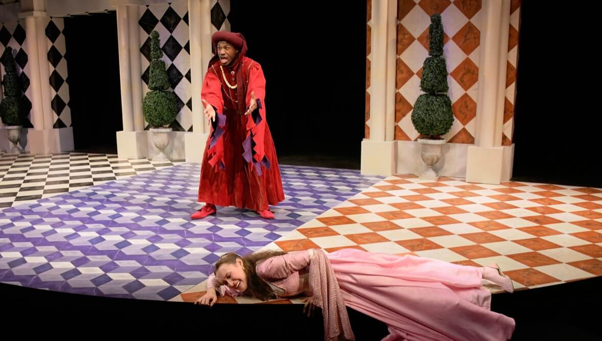 Sage-Floyd on stage in red costume