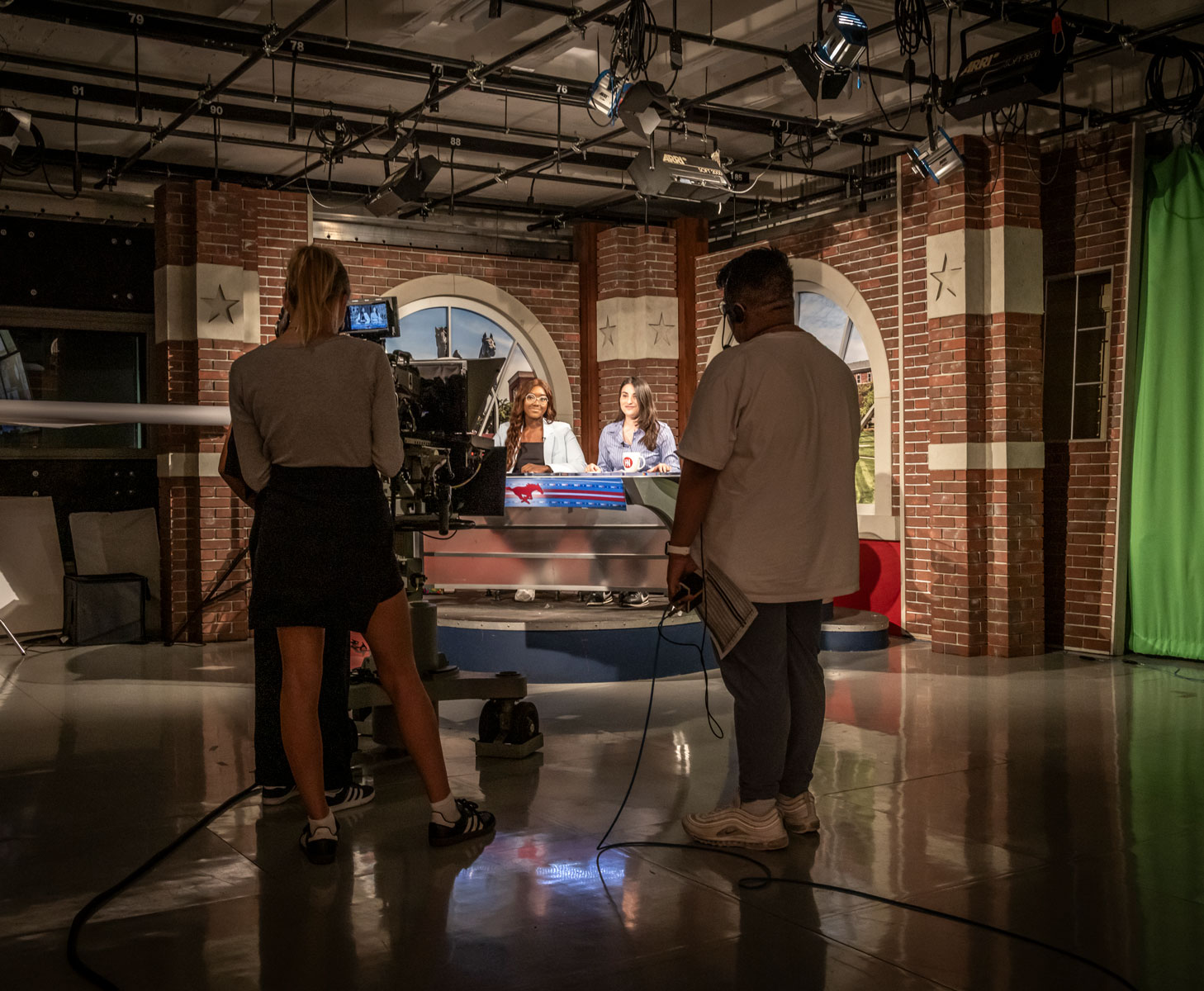 Student journalists work on the set of SMU-TV's Hilltop Now news program.