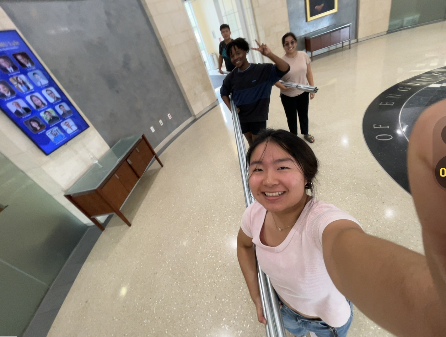 Percussion student Melody Tang carries newly-constructed pitched pipes with engineering students.