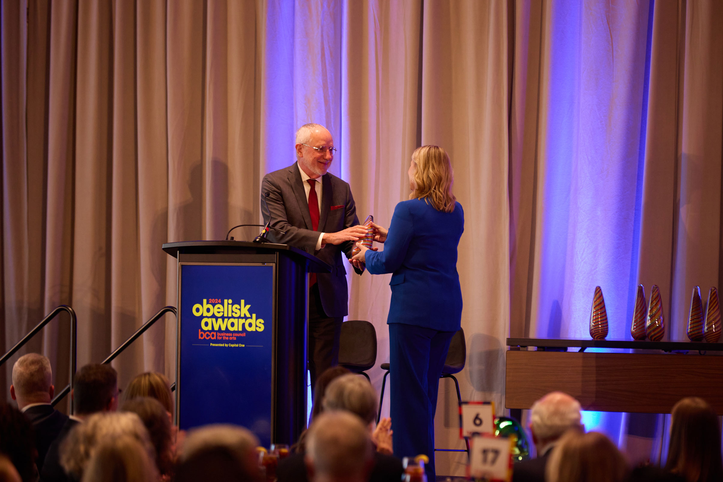 Dean Sam Holland receiving an Obelisk Award on stage