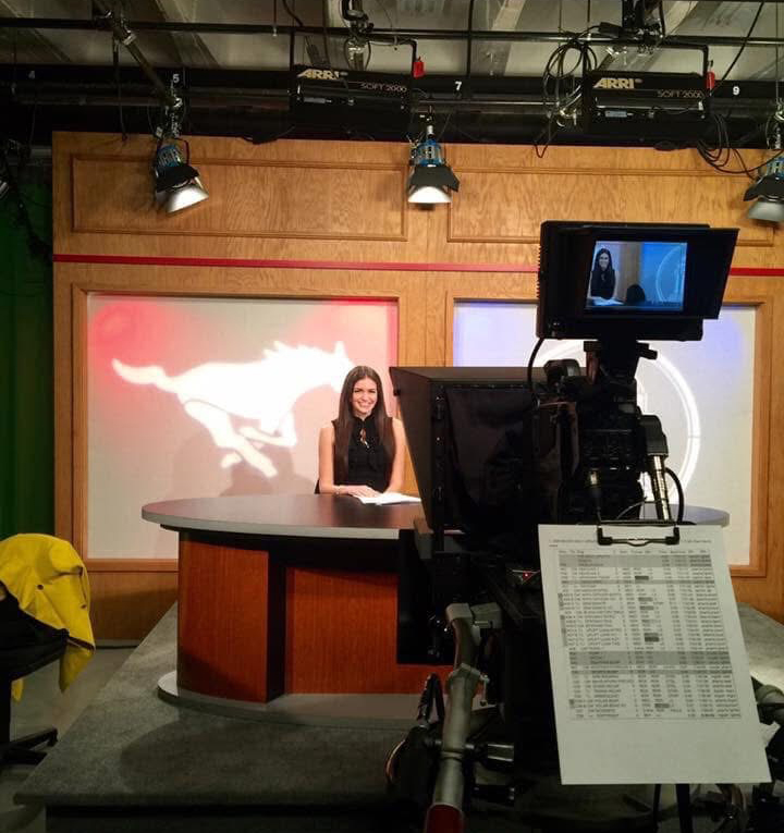 Journalism alum Cynthia McLaughlin sits in the SMU-TV studio during her time as an anchor in the program.