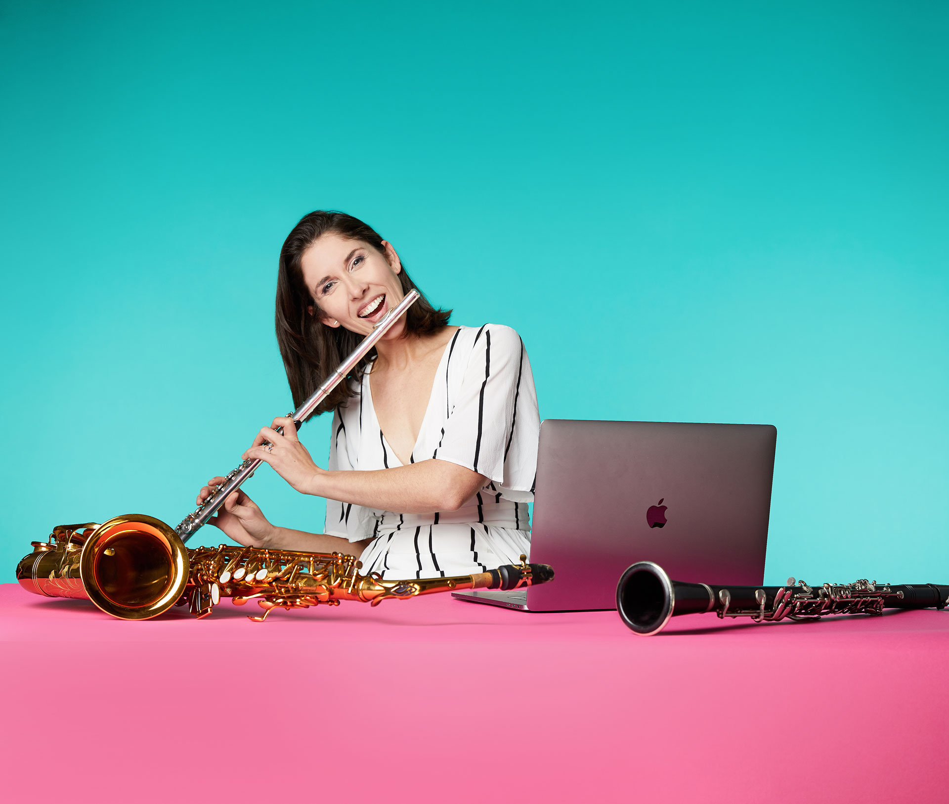 Alum Noelle Fabian Dragon plays an instrument in front of a laptop