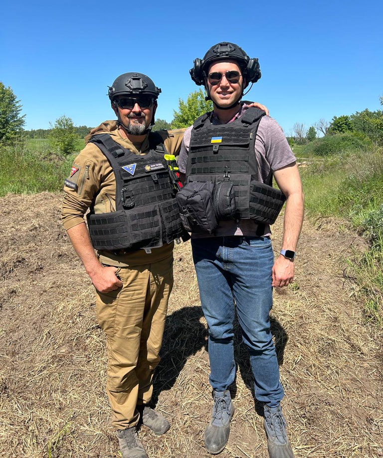 Music alum Paul Kroeger poses in a minefield in Ukraine.