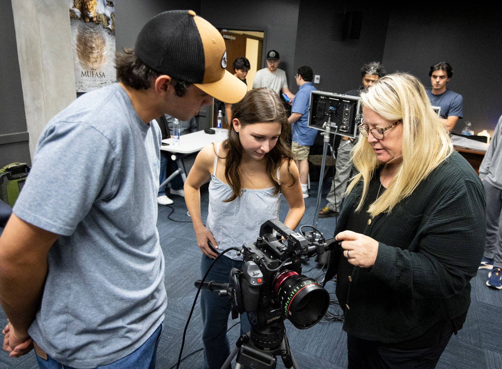 Cinematographer Shana Hagan instructs two Meadows students on camera work