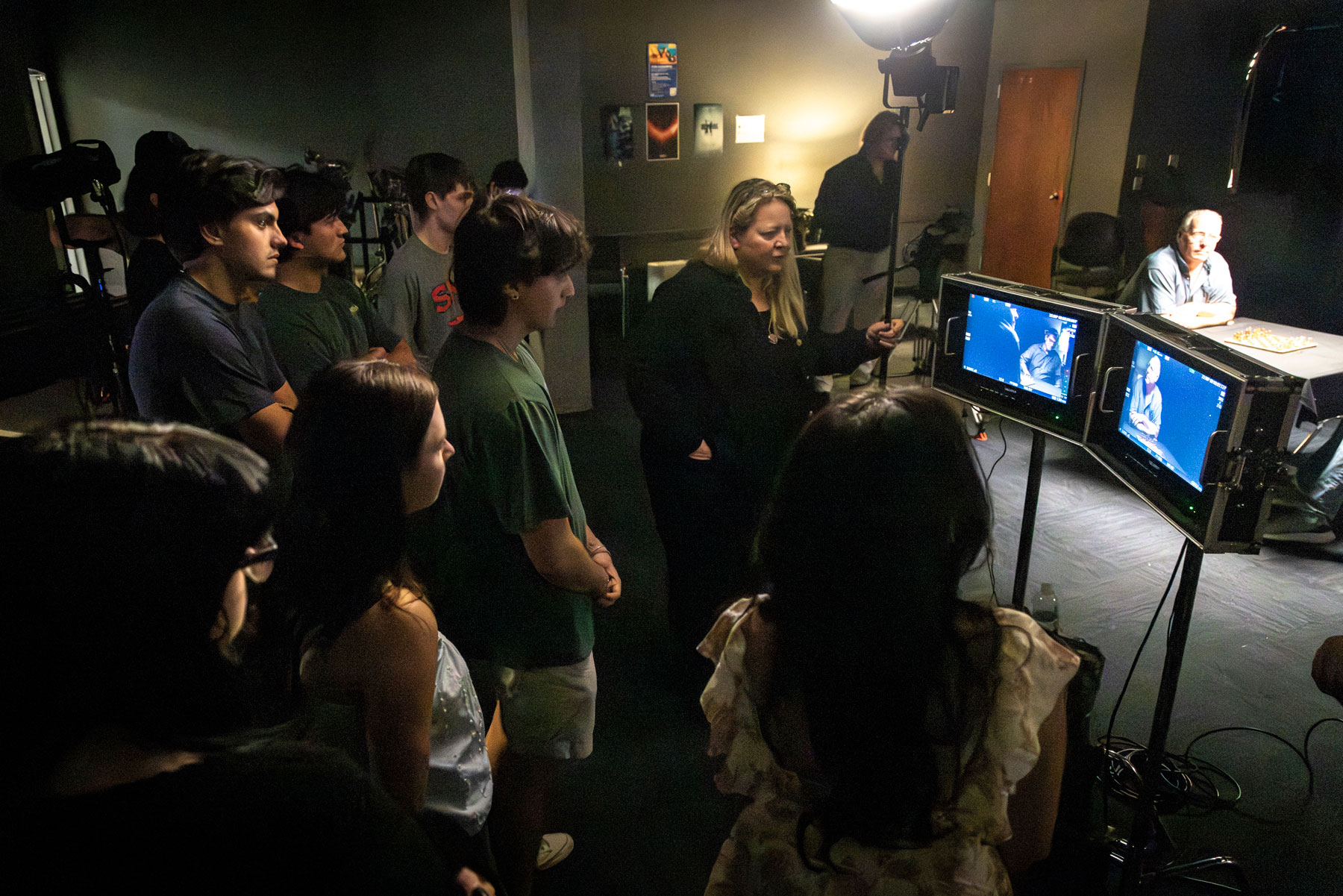 Cinematographer Shana Hagan and Meadows film students watch playback on screens