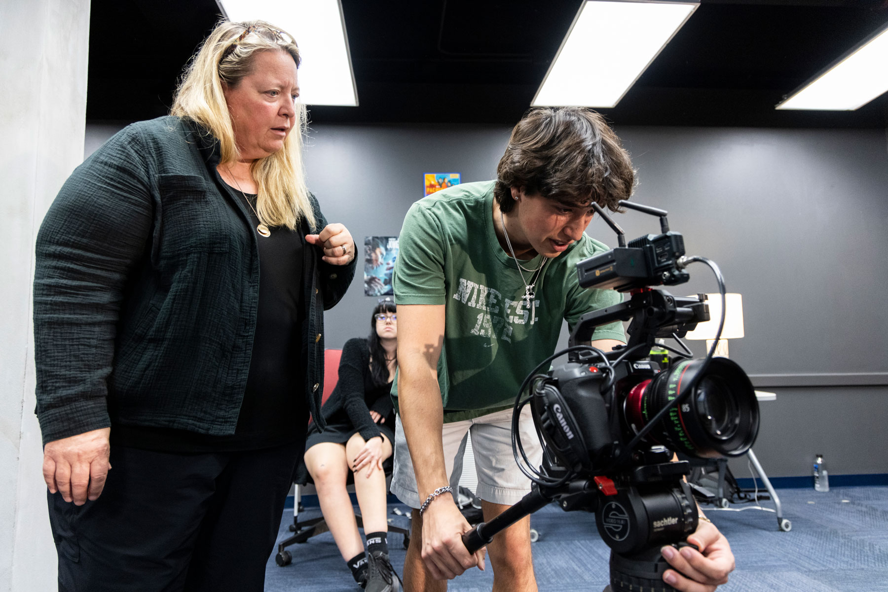 Cinematographer Shana Hagan instructs a Meadows film student on camera work