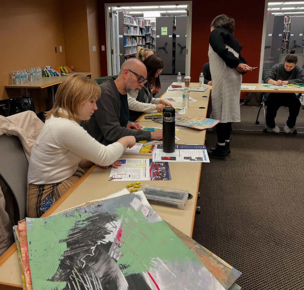 Art students use colorful oil pastels during a workshop by M.F.A. student Karina Ramirez.