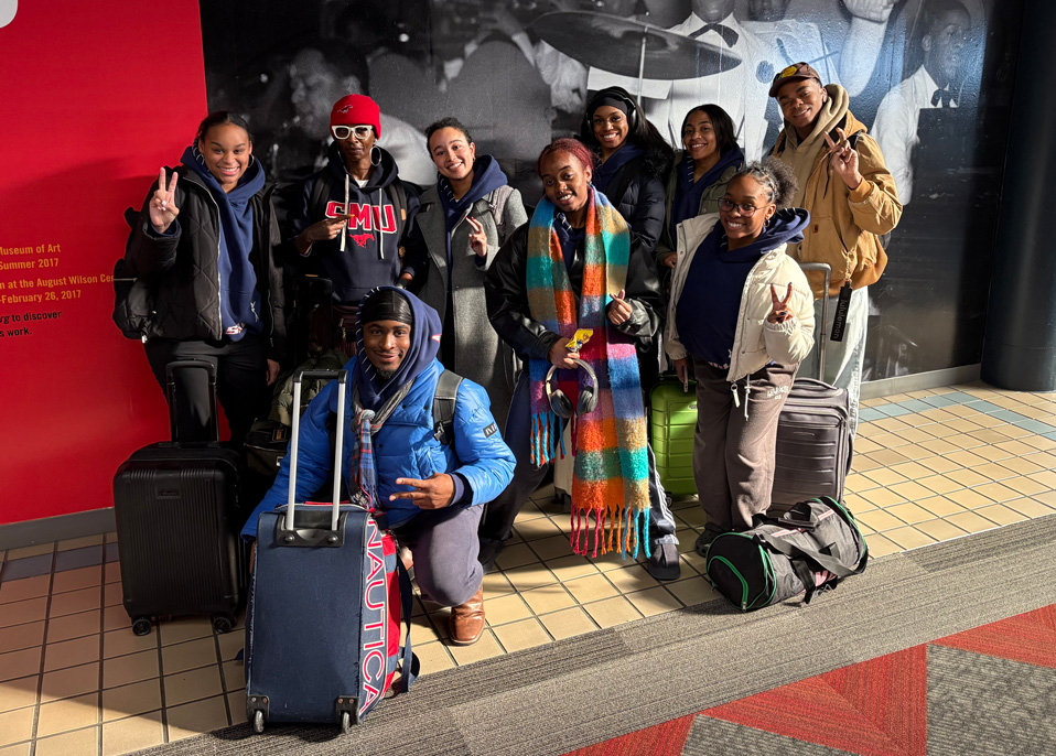 Dance students posing outside of the airport in Pittsburgh for the International Association of Blacks in Dance Conference