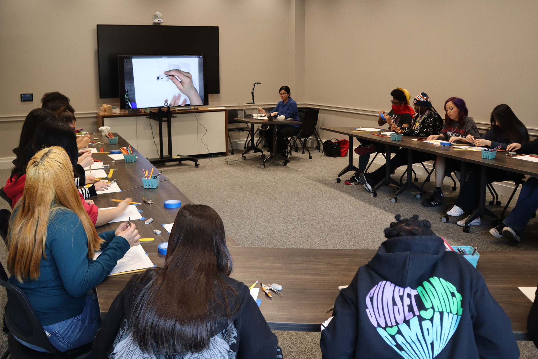 MFA student Sharmeen Uqaili conducts an artmaking workshop with local high school students