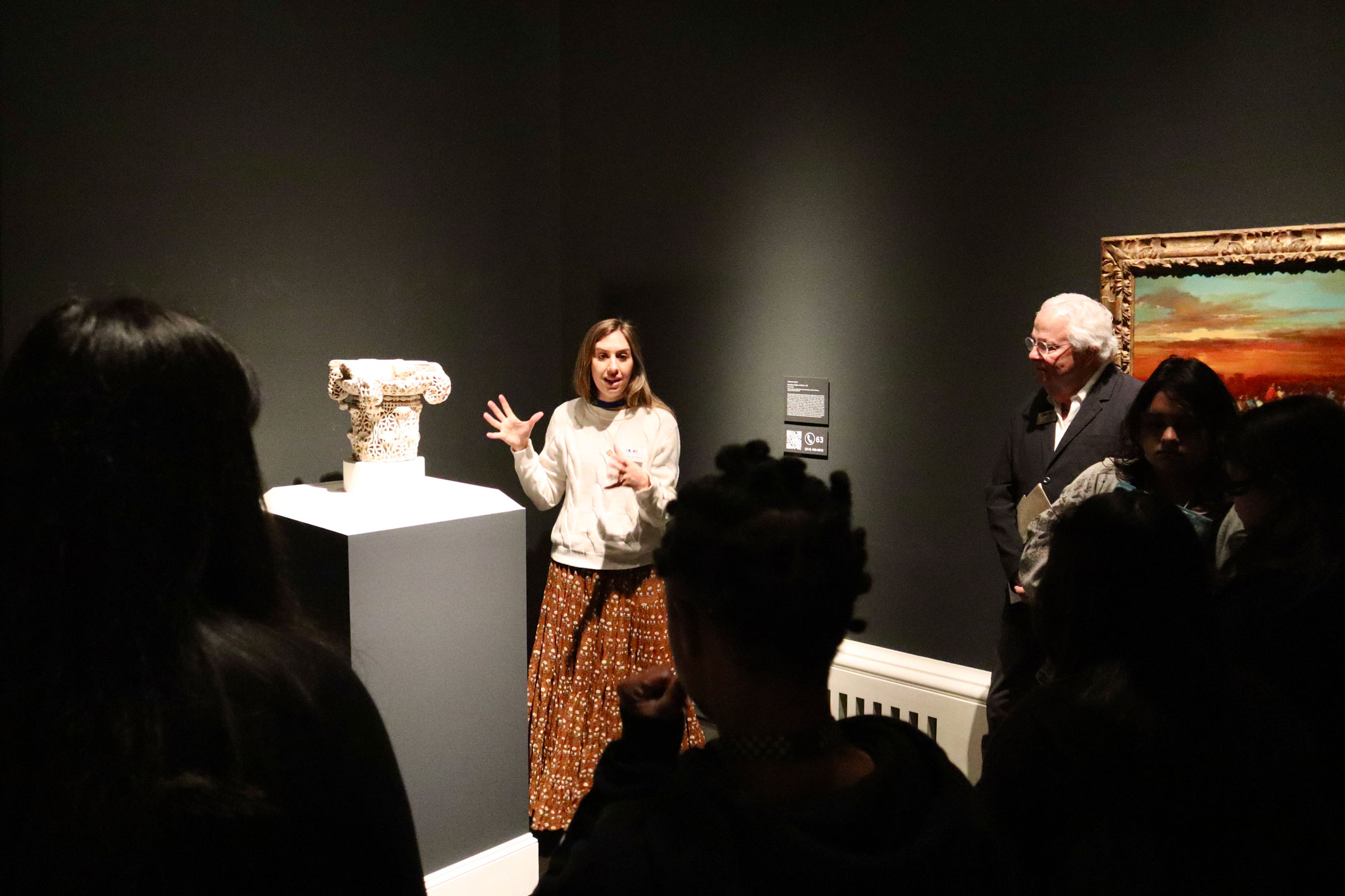 Local high school students experience a sculpture in an exhibit at the Meadows Museum