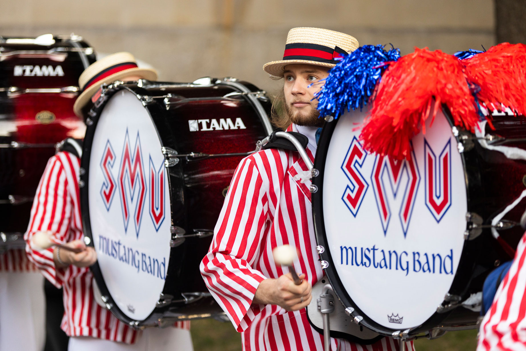 Members of the Mustang Band play drums in their red and white striped uniforms
