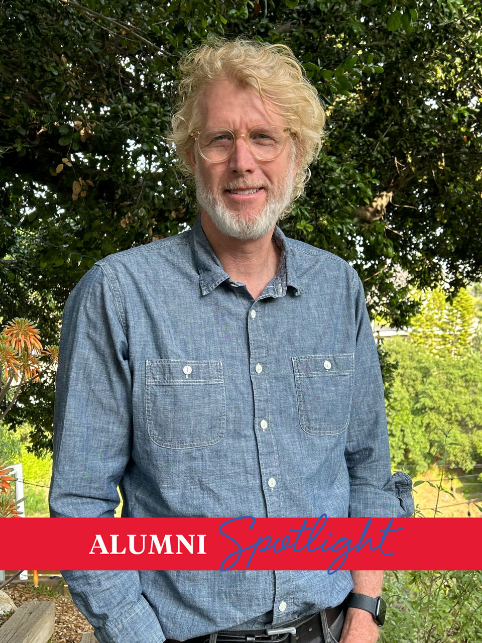 Film alum Rob Hoegee in a button down denim shirt and glasses