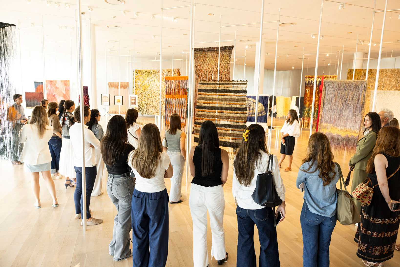 Art history alum Veronica Pesantes leads a gallery tour for her organization Miami Art Hang