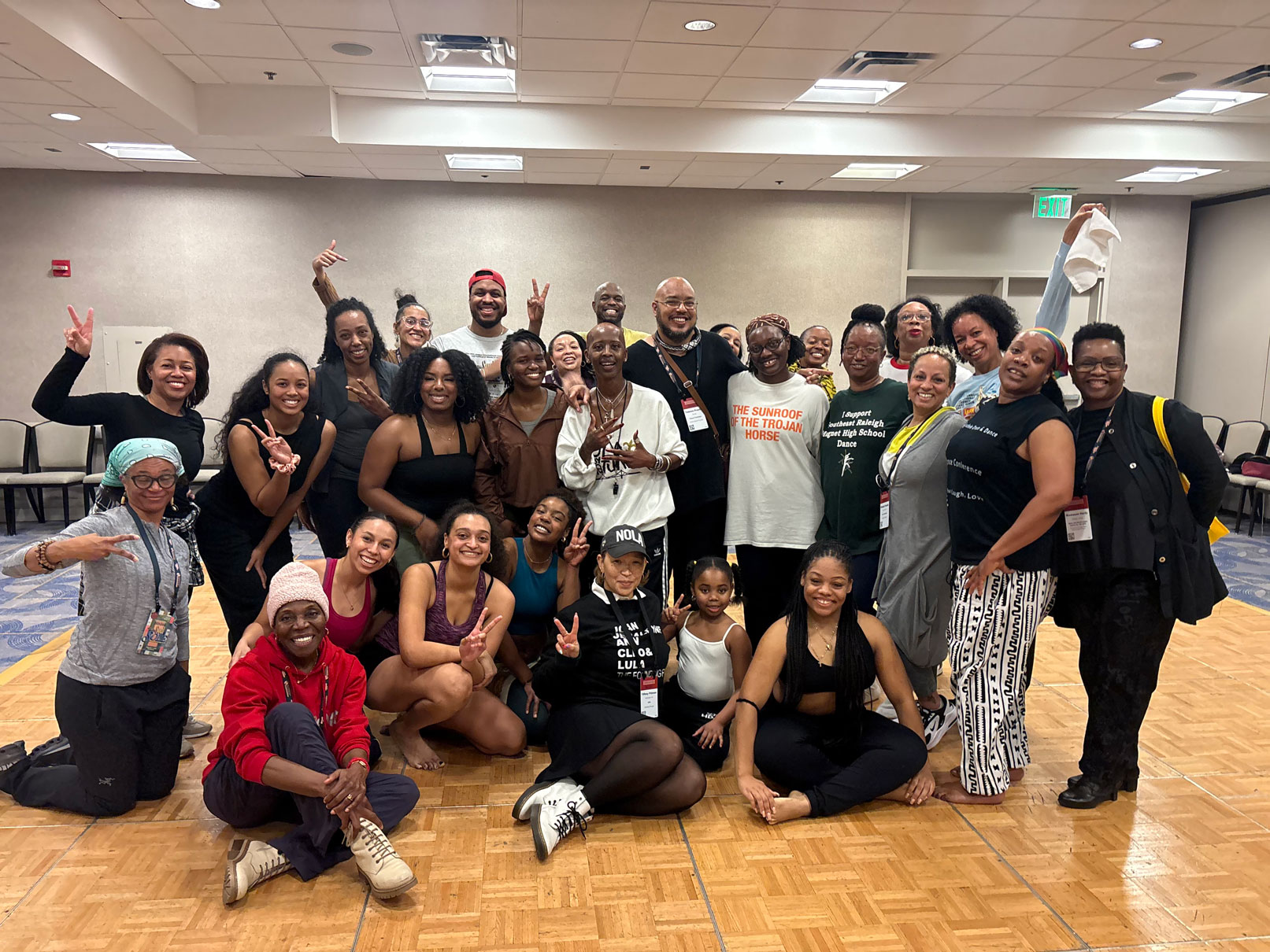 A group of dancers pose in a dance classroom following a choreography class
