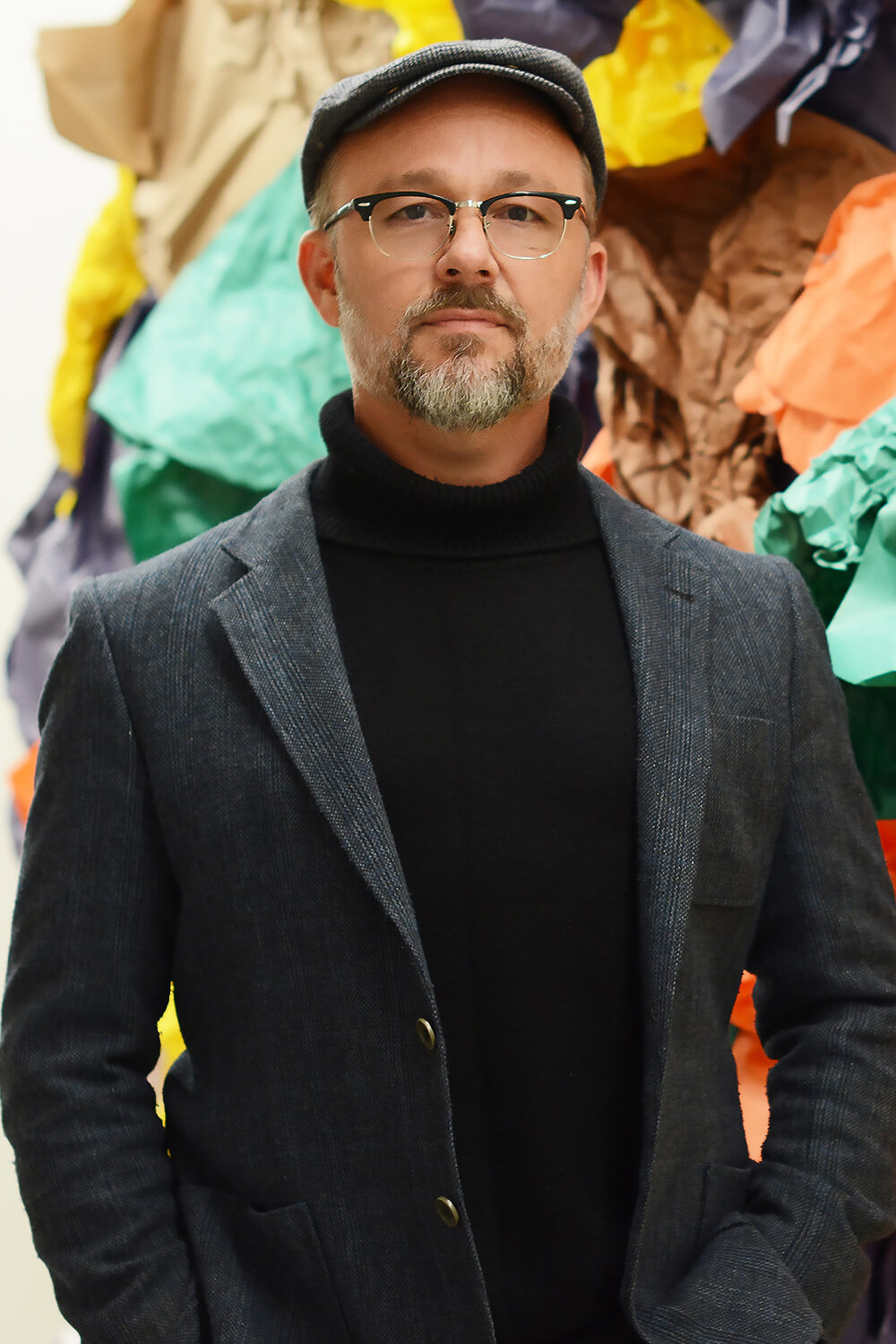 Professor of practice Jim Hart in glasses and a newsboy cap