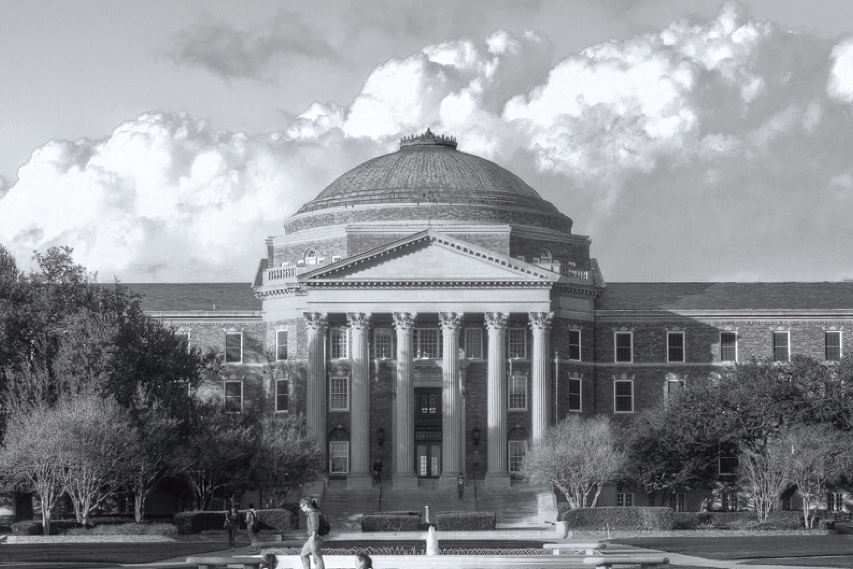 Black and white image of SMU’s Dallas Hall, symbolizing academic milestones like doctoral defenses.