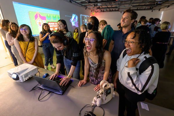 Group of students smiling and gaming