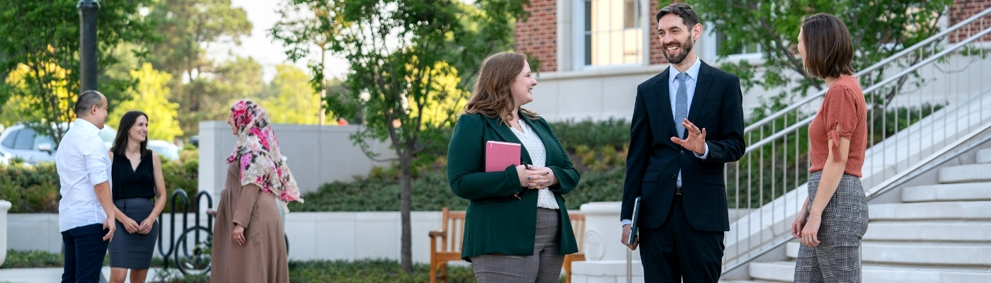 Graduate Students Outside Frances Anne Moody Hall