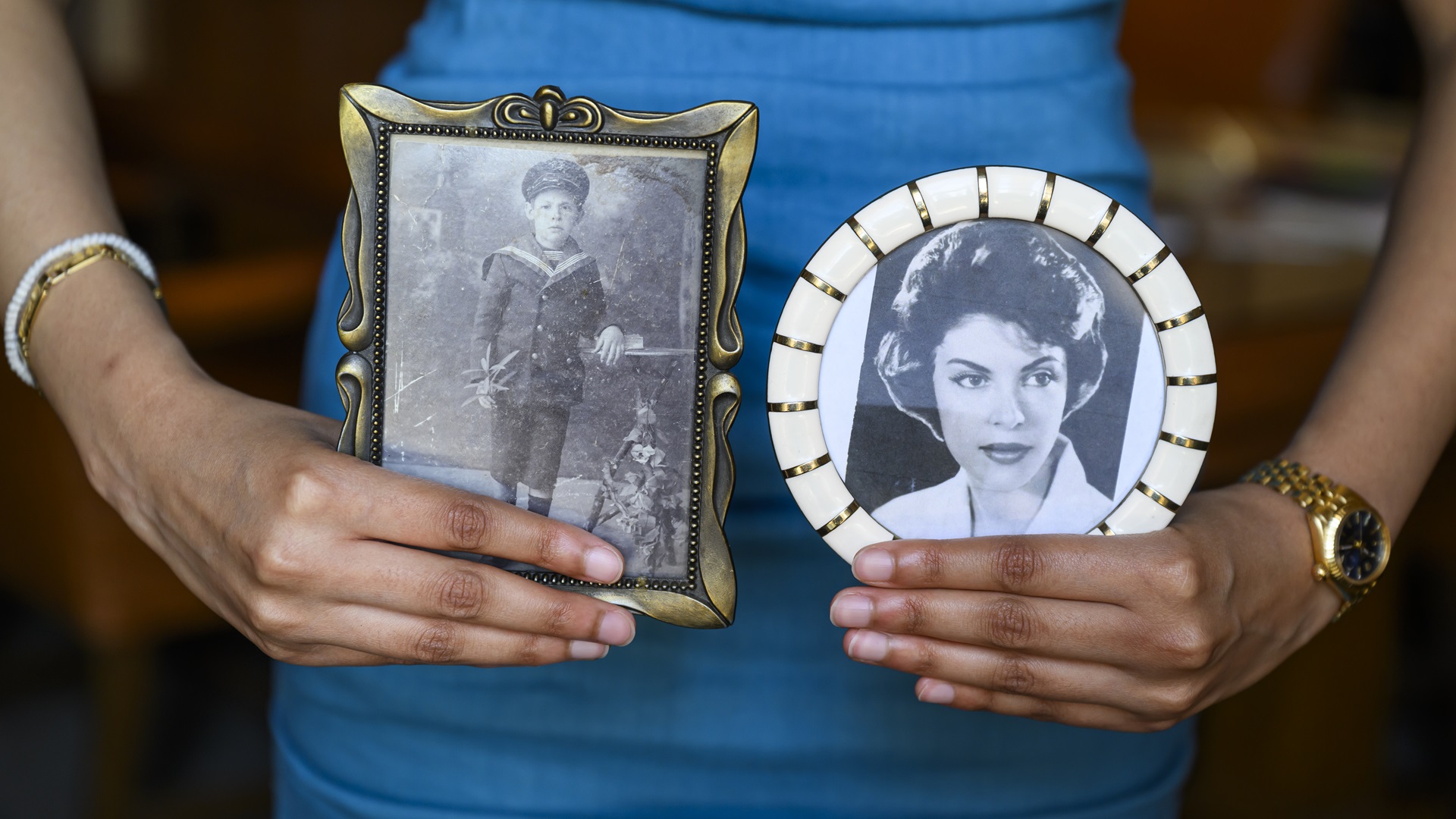 Alexandra Lahiri holding photos