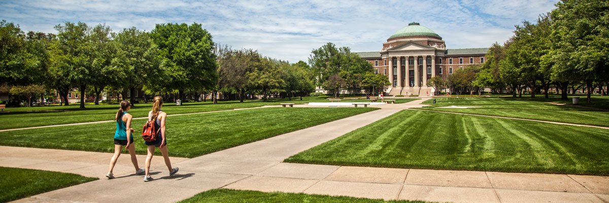 two students walking to Dallas Hall
