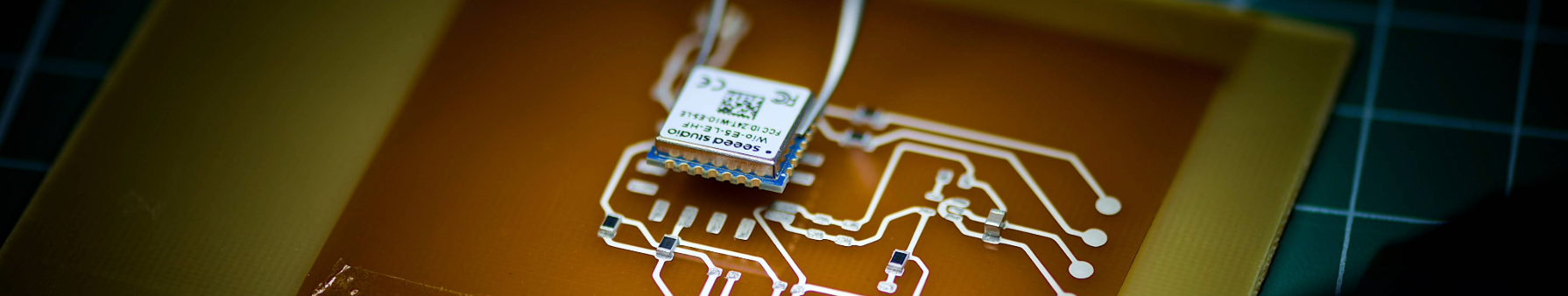 Component being placed on LoRaWAN circuit with pliers