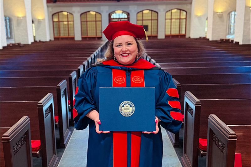 Image of Abbey Weaver holding her degree