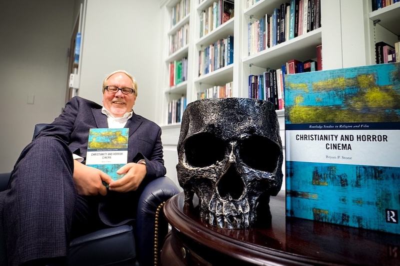 Dean Bryan Stone with his book, Christianity and Horror Cinema