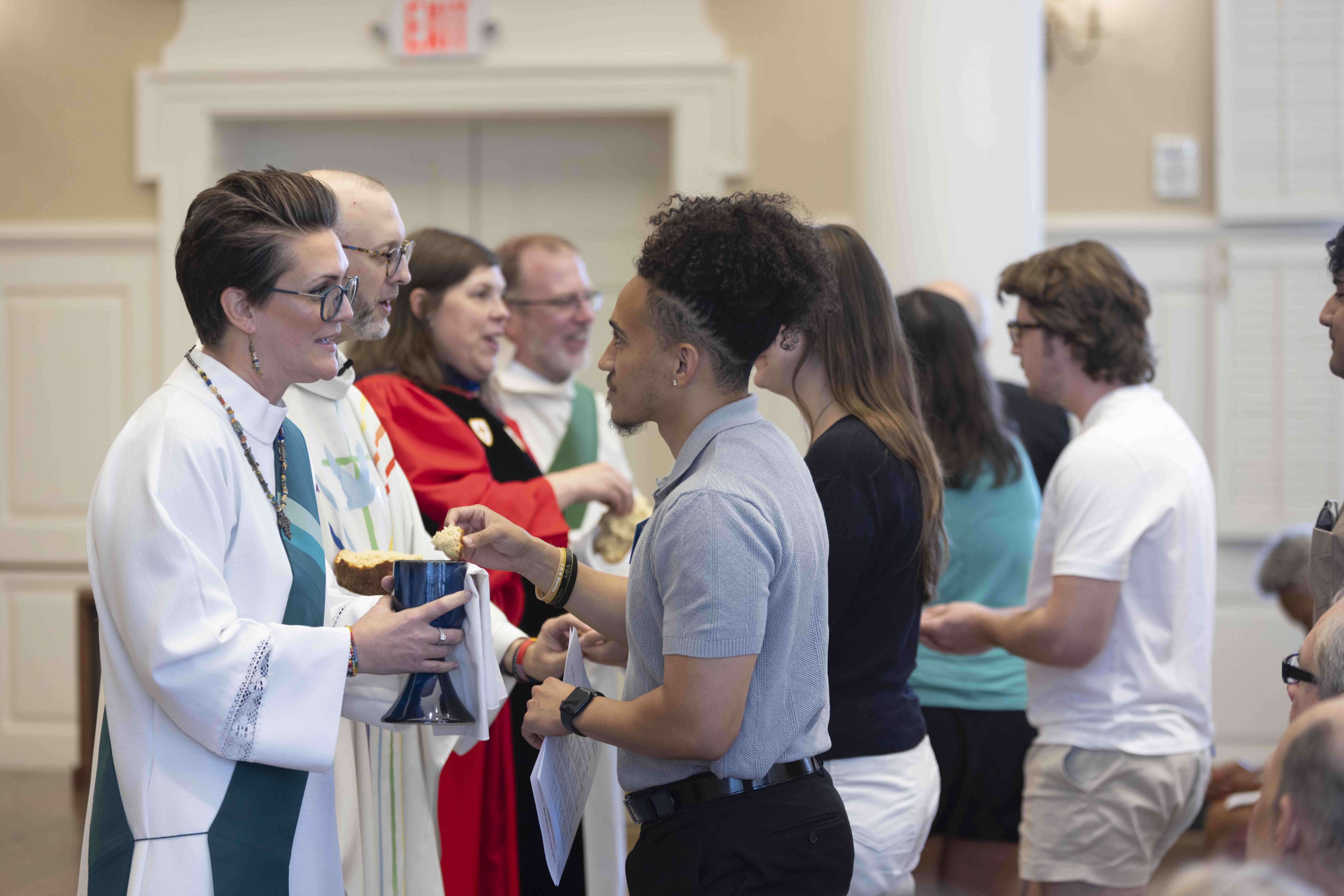 Graduates of the Master of Divinity program at Perkins School of Theology offer communion