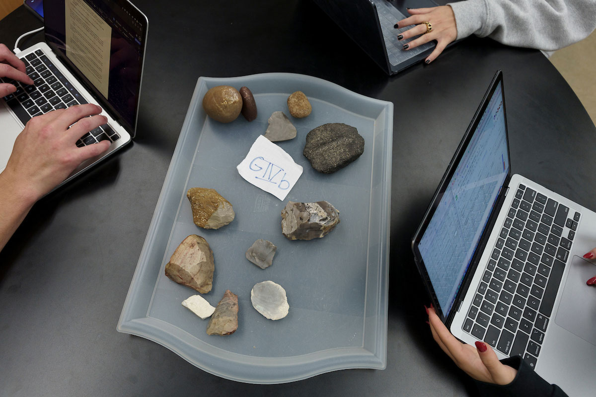 Researchers analyze geological samples and digital data during earth sciences and subsurface energy research.