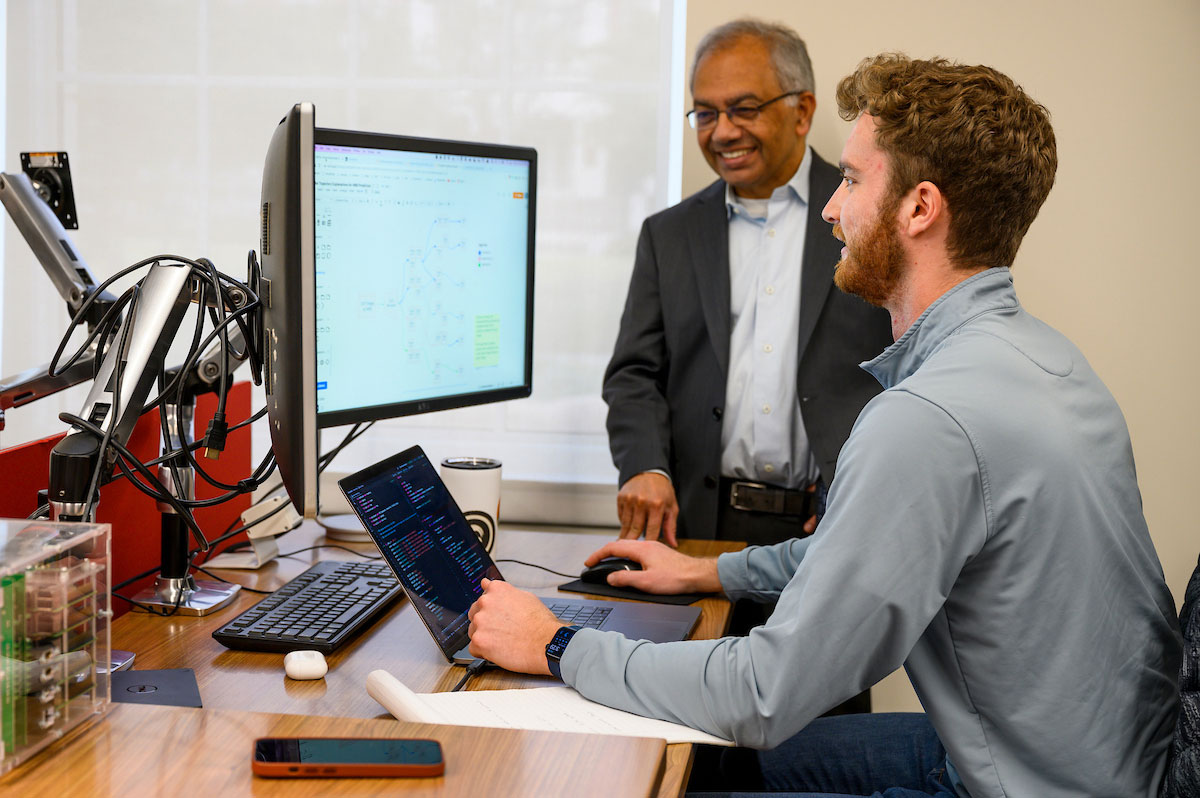 SMU faculty mentor a student working with data visualization and computing technology in a research and innovation setting.
