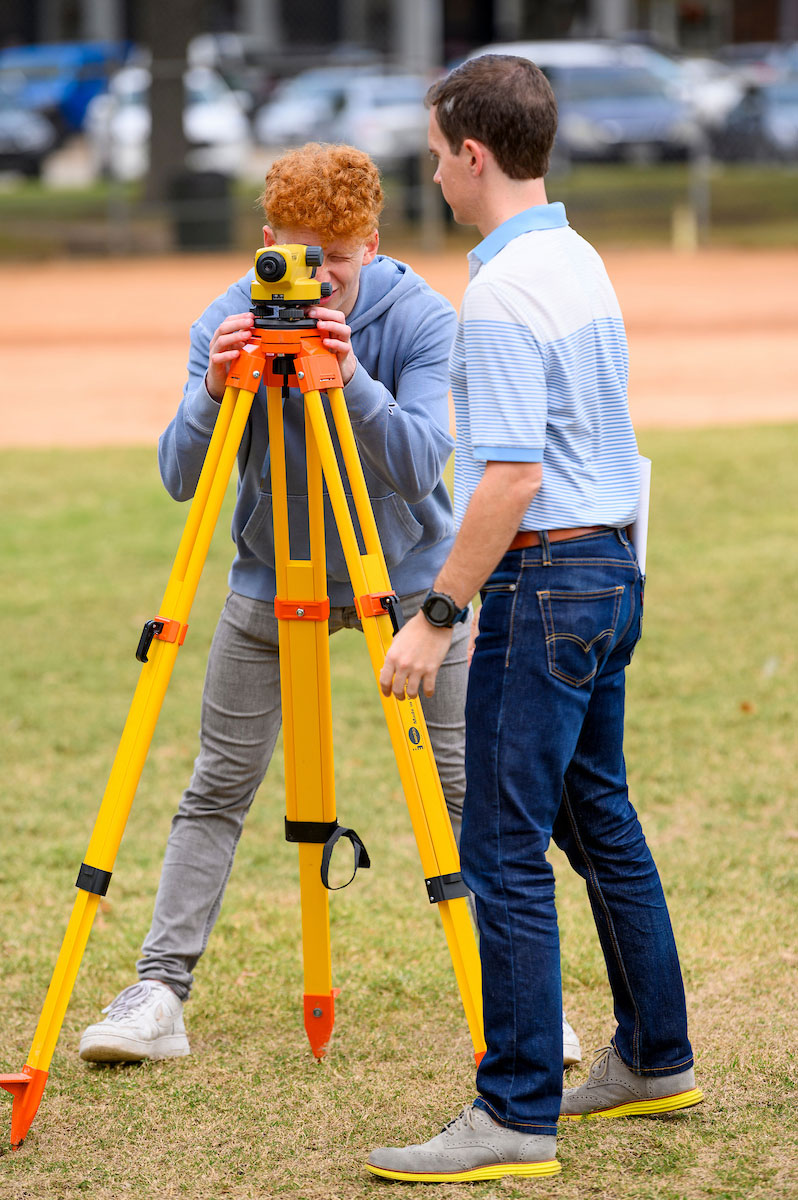 SMU students gain hands-on technical experience using surveying equipment during an outdoor field-learning activity.