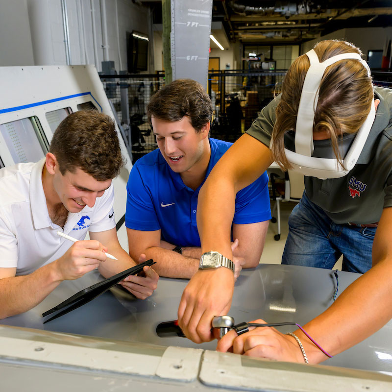 SMU students collaborate on hands-on engineering and technical work in an advanced manufacturing lab environment.