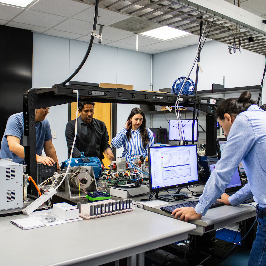 Students collaborate in an advanced engineering lab using computers, instrumentation, and energy systems equipment.