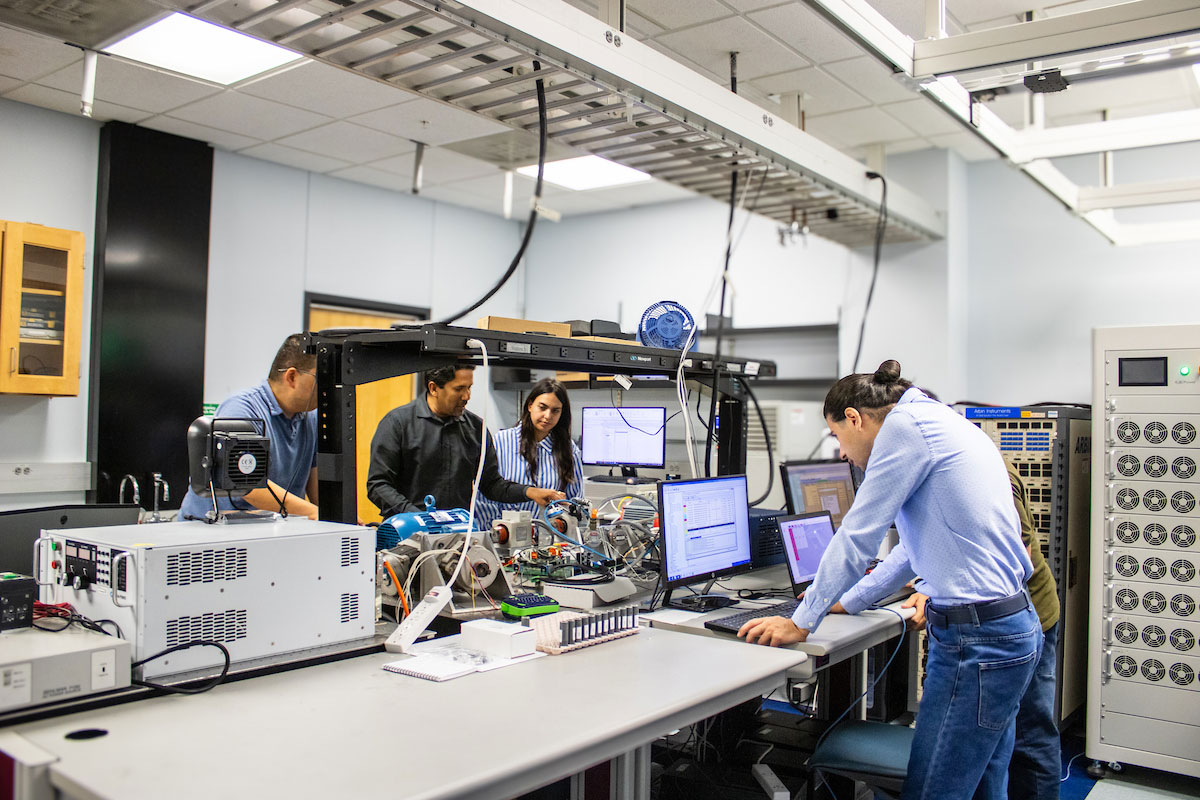 Researchers collaborate in an advanced engineering lab using computing systems, instrumentation, and energy systems technology.