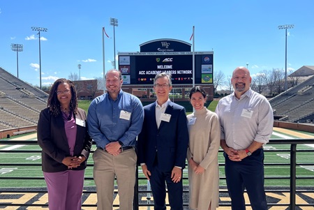 ACC ALN faculty standing in front of the Wake Forest University Stadium