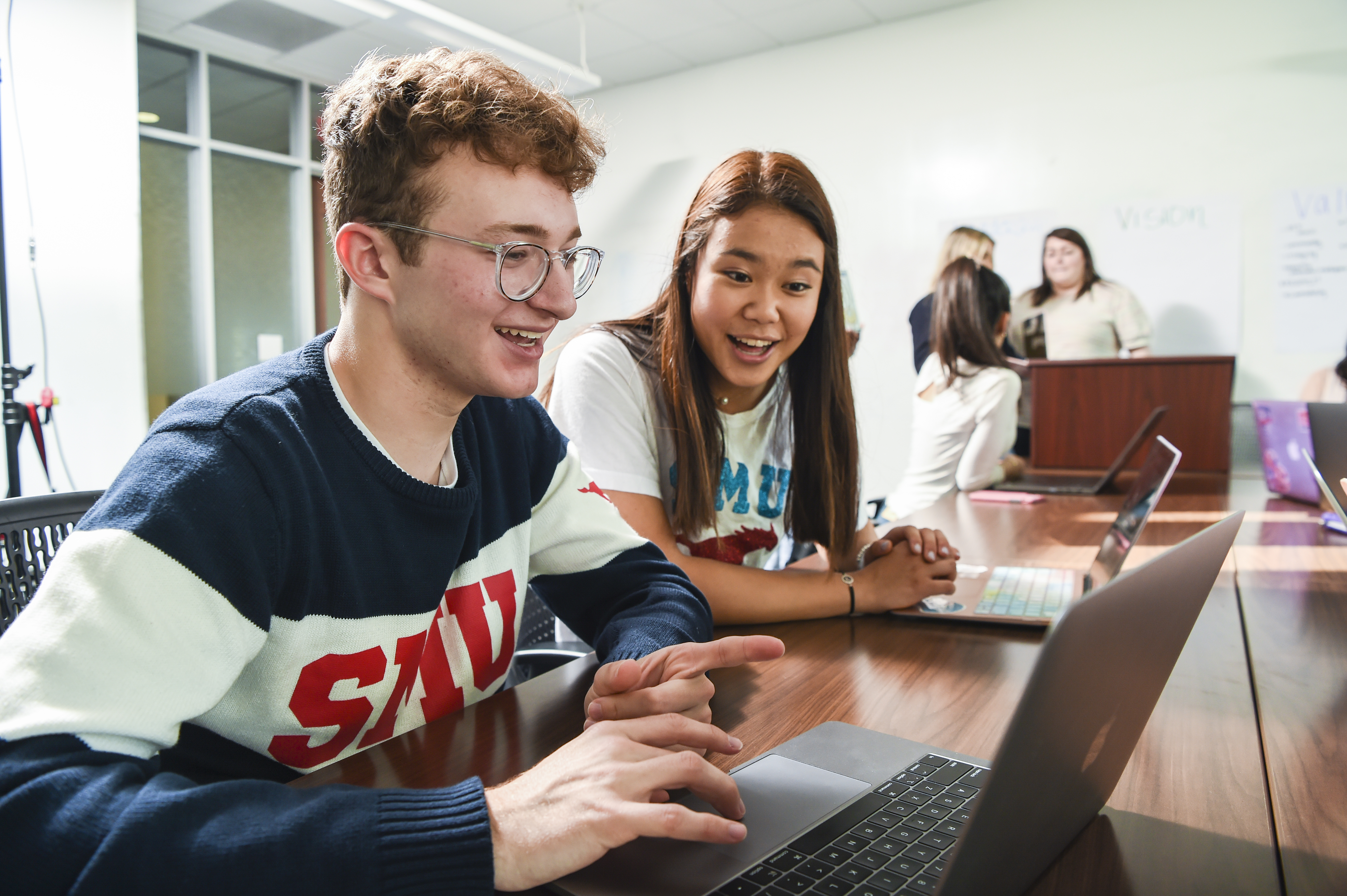 Students studying together on laptops